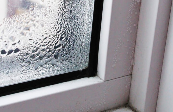 Water droplets and condensation on window glass showing monsoon leakage needing sealing