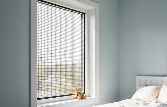 Fixed mosquito mesh installed on home windows for insect protection